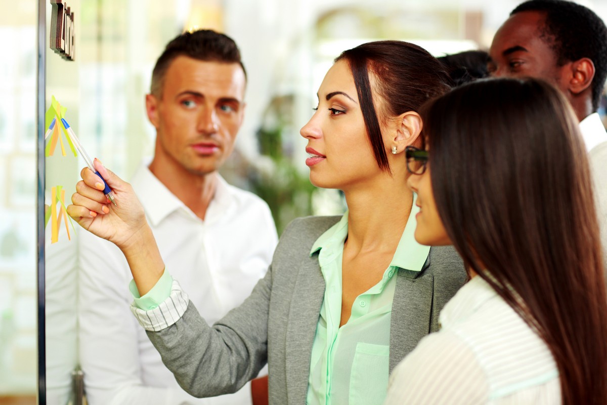 Businesswoman points at the notes in office
